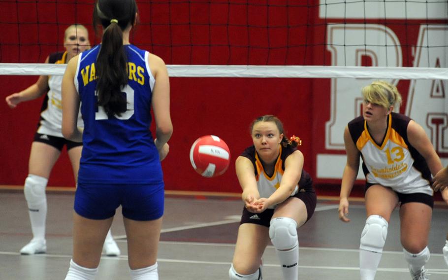 Baumholder's Charlee Schroeder, center, digs deep to return a Wiesbaden shot in their match in Kaiserslautern, Germany, on Saturday. Wiesbaden won 25-13, 25-10, 19-25, 25-17. Watching the action from left are Brandi Burkey, Andrea Armold and Alexandra Bower