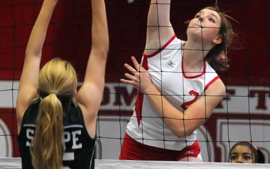 Kaiserslautern's Karah Helm, right, knocks the ball over the net past SHAPE's Rachel O'Neill. SHAPE won the match in Kaiserslautern, Germany, on Saturday, 25-17, 25-6, 25-22