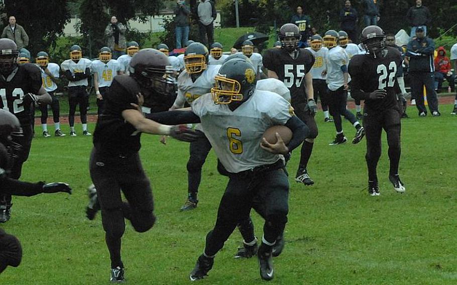 Sterling Jones of Heidelberg tries to elude the Vilseck defense during the Lions' 14-0 victory Saturday in Vilseck. Jones rushed for 61 yards on 14 carries and scored the game's first touchdown on a 21-yard pass completion from Kevin Gray.