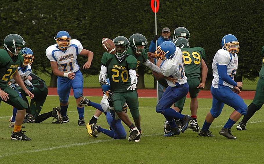 Alconbury running back Dominique Littleton loses control of the football after avoiding a tackle from Sigonella linebacker Brandon Albert. Littleton regained control of the ball before it hit the ground. 