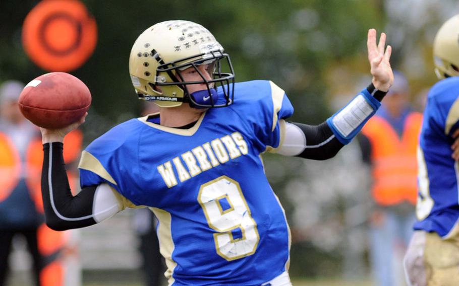 Wiesbaden's Ryan Reagin gets ready to launch his 75-yard touchdown pass to Antonio Trawick as the Warriors beat the visiting Vilseck Falcons, 34-7, in a Division I-South game on Saturday.