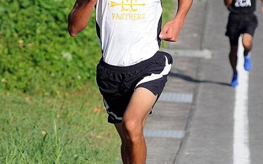 Kadena senior Tomas Sanchez makes his way up the final hill with Zion Christian Academy's Mashu Wakita well in his wake during Tuesday's Okinawa Activities Council boys cross country race at Jack's Place 3.1-mile course, Kadena Air Base, Okinawa. Sanchez won in 17 minutes, 19 seconds, his second victory of the season.