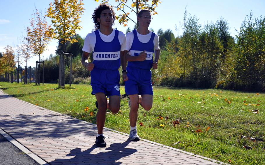 Hohenfels seniors Drew Martin, left, and Dan Cochran pace one another during a race Saturday in Bamberg. Martin finished first for the boys with a final time of 19 minutes, 10 seconds, three seconds ahead of Cochran.