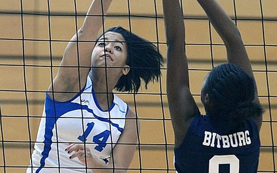 Wiesbaden's LeAmber Thomas, left, knocks the ball over Ellisia Kimble's outstretched arms in Wiesbaden's 25-16, 25-14, 25-13 win over the visiting Lady Barons on Saturday. 