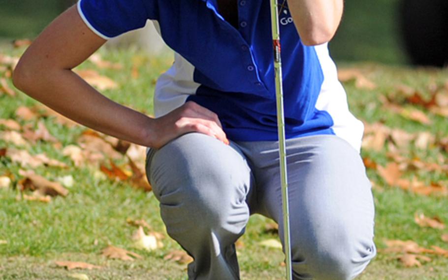 Defending champ Hollie Salvo of Wiesbaden studies a putt on opening day of the DODDS-Europe golf championships at Wiesbaden&#39;s Rheinblick golf course on Thursday.