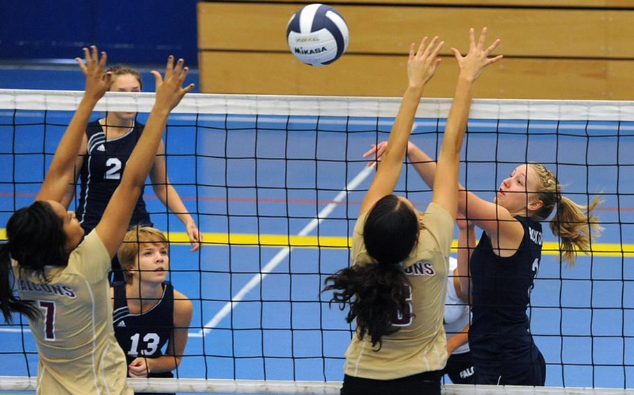 Black Forest Academy's Meredith Powell, right, knocks the ball over the net against the Vilseck defense of Sidni Beaulieu-Hains, left, and Theresa Trevino. Vilseck, last year's Division I runner-up defeated the defending Division II champs 25-14, 25-23, 25-13 in Heidelberg, on Saturday. Watching the action are, from left, BFA's Kate Woodward and Kara Brown.