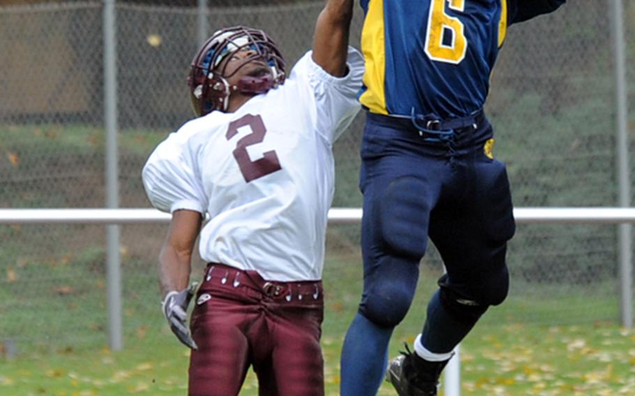 Heidelberg's Sterling Jones, right, pulls in a Kevin Gray pass over Vilseck's Xavier Scott and goes in for the touchdown as the Lions beat the Falcons, 34-6, in their homecoming game in Heidelberg, on Saturday.