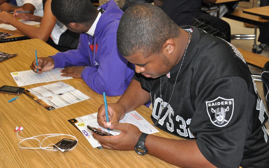 Bamberg senior Demetrius Lindsey fills out a National Collegiate Scouting Association recruiting form at the Bamberg High School gym after attending a seminar led by former professional football player Derrick Mayes called ''College Recruiting Simplified.'' Lewis was one of about 50 Bamberg student-athletes present. Mayes addressed similar groups at several high schools during a three-day visit to Europe.