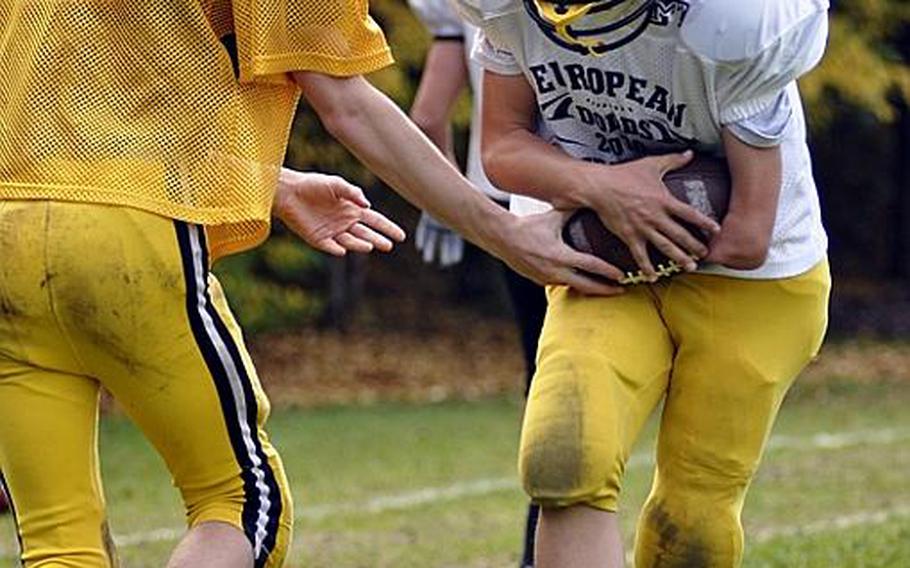 Anthony Coltson, 15, a tight end and wide receiver for the Patch junior varsity football team, grabs a handoff during a practice drill at Patch Barracks. Coltson, who was born with a left arm that ends just below his elbow, also plays ice hockey, soccer and baseball.