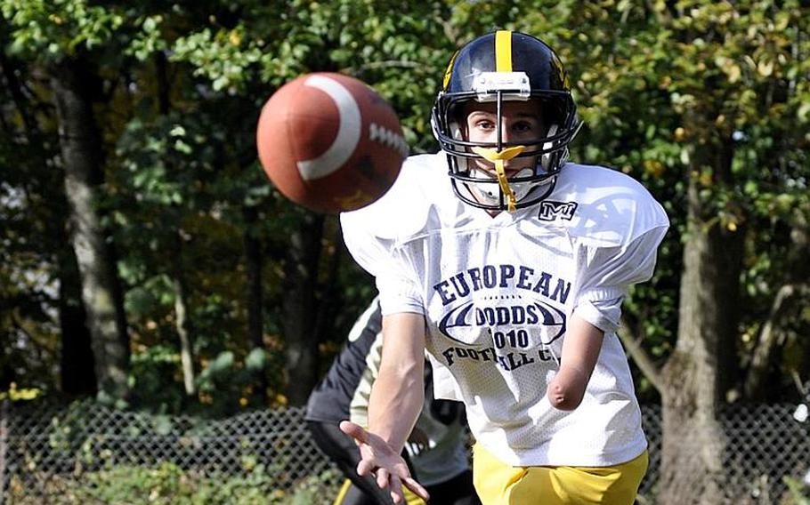 Anthony Coltson, 15, a tight end and wide receiver for the Patch junior varsity football team, reaches for a pass during a practice on Patch Barracks. Coltson was born with a left arm that ends just below his elbow, but he has not let that prevent him from participating in football and other team sports. His friends and teammates say they consider him an inspiration.