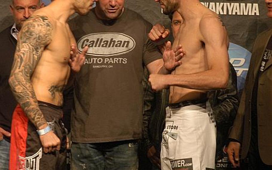 Ultimate Fighting Championship President Dana White separates Dan Hardy, left, and Carlos Condit at the UFC Fan Expo official weigh-in, Oct. 15 at London's Earls Court Exhibition Center. The two fought later that day.