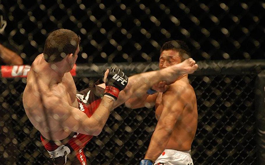 Britain's Michael "The Count" Bisping barely misses with a kick to the face of Japanese fighter Yoshihiro Akiyama during the UFC 120 main event at the O2 Arena in London. Bisping defeated Akiyama by a unanimous decision.