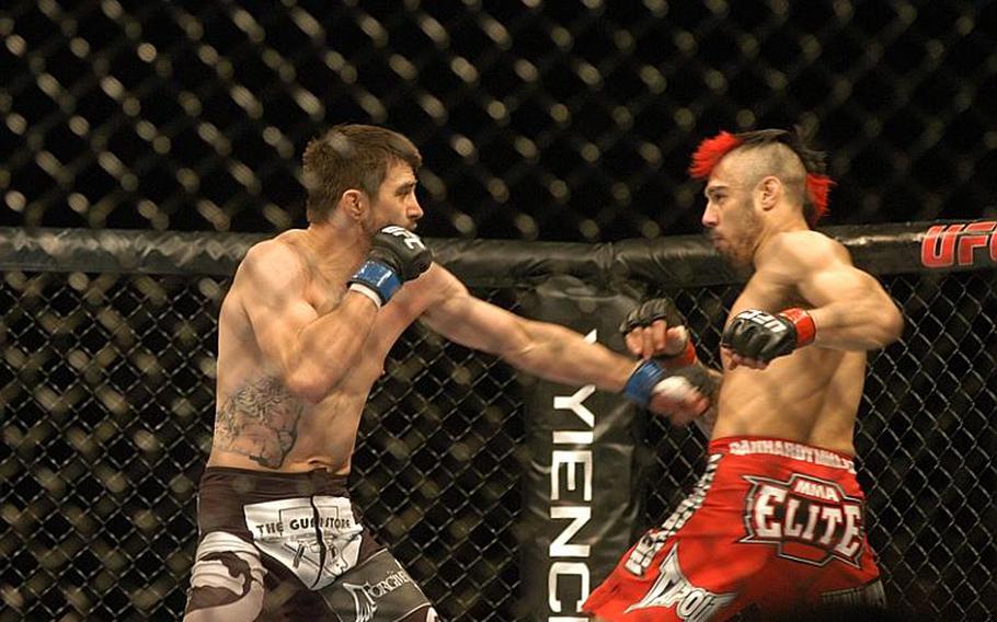 American Carlos ''Natural Born Killer''' Condit, left, misses with a punch in the opening moments of his fight against British fighter Dan '''The Outlaw'' Hardy. Condit caught Hardy with a  left hook a short time later and knocked him to the ground to end the fight via TKO.