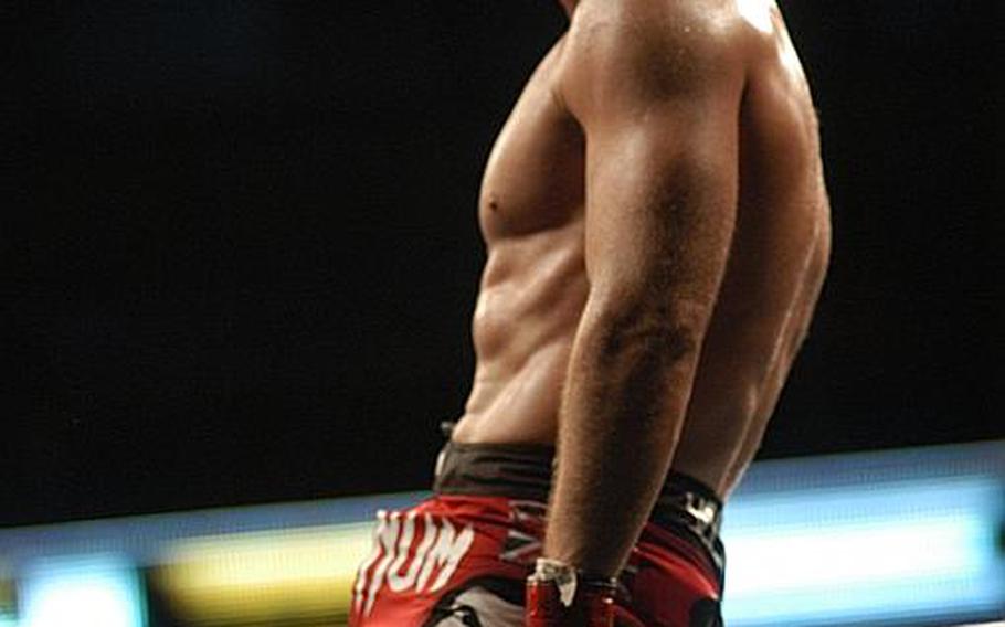 British fighter Michael ''The Count'' Bisping sits atop the fence surrounding the UFC ''Octagon'' and soaks in the cheers of the London crowd at the O2 Arena after beating Japan's Yoshihiro Akiyama at UFC 120.