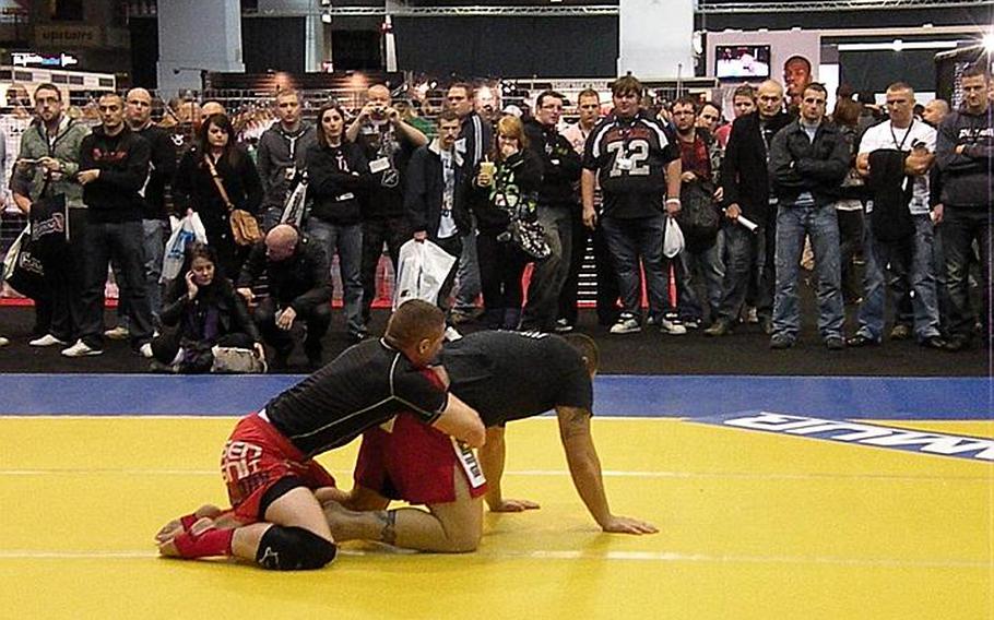 Mixed martial-arts fans watch a wrestling demonstration at the first Ultimate Fighting Championship Fan Expo held in the United Kingdom on Oct. 15-16.