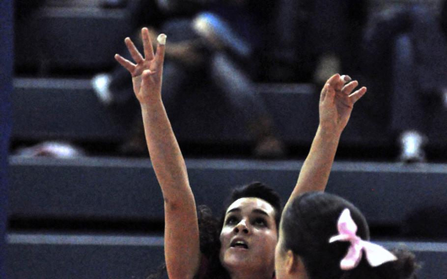 Aviano's Megan Duck watches sophomore AnnMarie McClelland set the ball Saturday during the Saints' 25-13, 25-15, 26-24 victory over Marymount International. The victory kept Aviano perfect in league play and set up a clash next weekend with Vicenza for the league title.