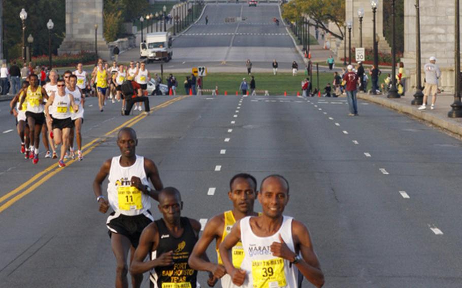 Eventual Army 10 Miler winner Alene Reta, right, leads the field across the Memorial Bridge into Washington, D.C., on Sunday. In the background is Arlington National Cemetery. Close behind Reta are eventual runner-up Tesfaye Sendeku, Joseph Chirlee (41) and All-Army Team member Robert Cheseret (11).