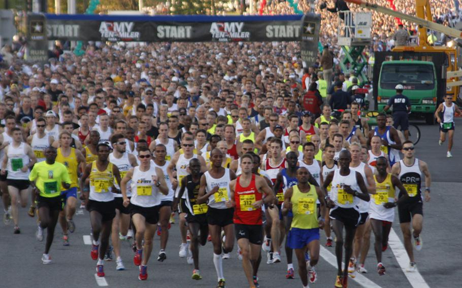 The field of 30,000 runners crosses the starting line.