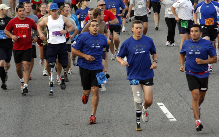 Wounded warriors and wheelchair competitors break from the starting line.