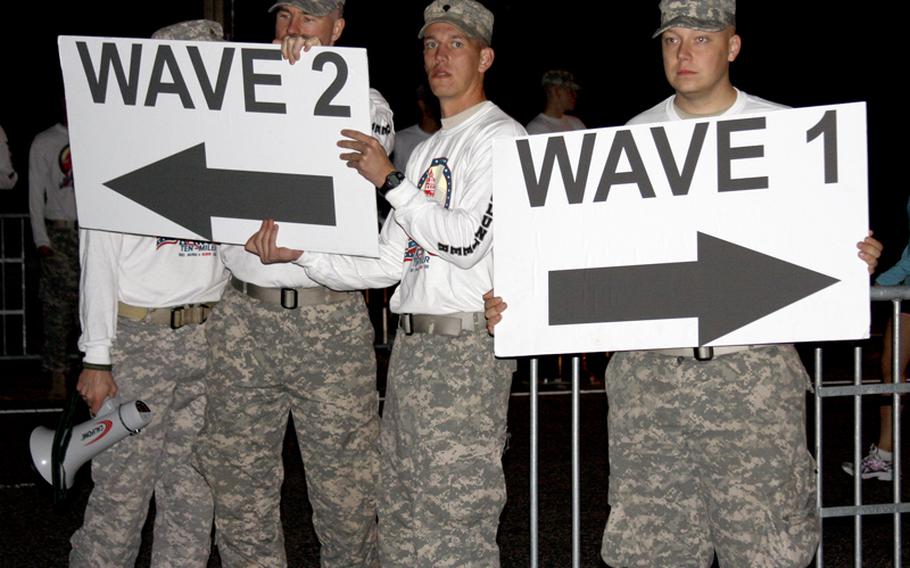 Runners are directed to their part of the starting area in the pre-dawn hours before Sunday's Army Ten Miler at the Pentagon.