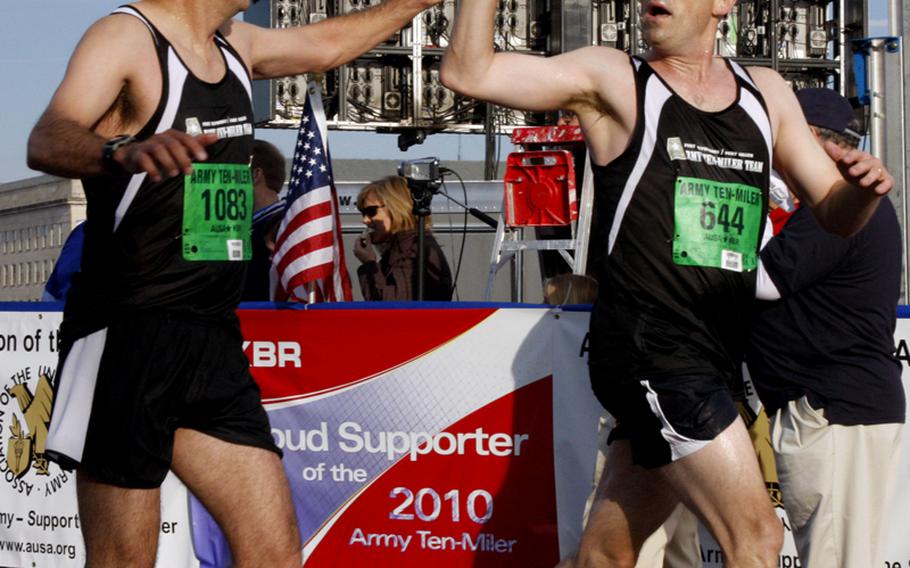 John Ruibal of McDonough, Ga., and Brian Lein of Peachtree City, Ga., celebrate at the finish line.