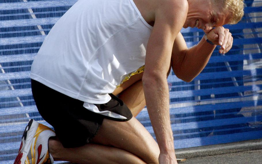 John Mickowski of Colorado Springs, Colo., tries to catch his breath after crossing the finish line in 10th place at Sunday's Army 10 Miler at the Pentagon. Mickowski's time was 49:40.