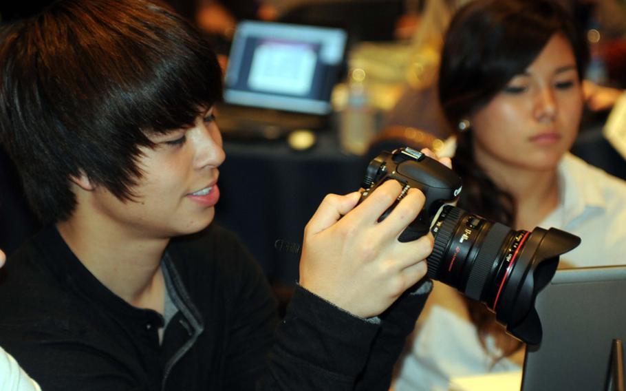 Zama American senior Nick Jorgenson checks photos for his six-person news team during Monday's photography session in the 2010 DODDS-Pacific Far East Journalism Conference at Tokyo's New Sanno Hotel. Jorgenson is also a tennis player and missed this week's Kanto Plain Association of Secondary Schools tournament in preparation for next month's Far East tennis tournament on Okinawa, an example of how DODDS Pacific's expanding Far East Activities Calendar gives students more options and opportunities than they'd have in the States, though students also have to make difficult choices as to which events they attend.