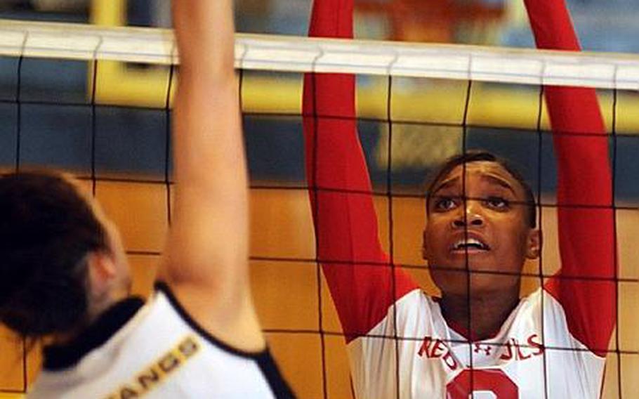 Elena Wadden of the American School In Japan tries to spike past the block of Mashiya McKinney of Nile C. Kinnick during Thursday's Kanto Plain Association of Secondary Schools girls volleyball match at Mustang Valley, Tokyo. Kinnick won 25-11, 25-21, 23-25, 25-16 to remain tied for first place atop the league with Seisen International.