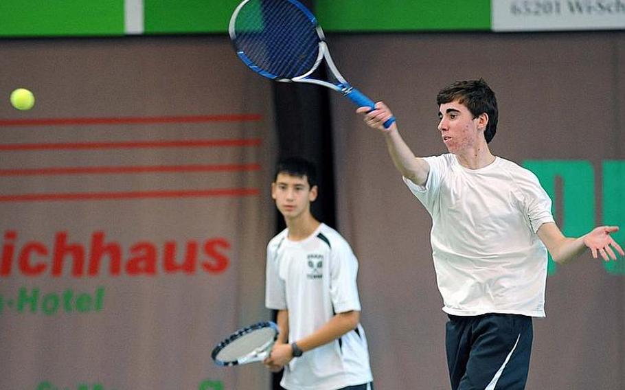 SHAPE's Alvaro Sanchez returns a shot against Ramstein as teammate Aaron Yip backs him up. The unseeded team beat Lee Debose and Forrest Kampermann, the third seed, to advance to Saturday's final.