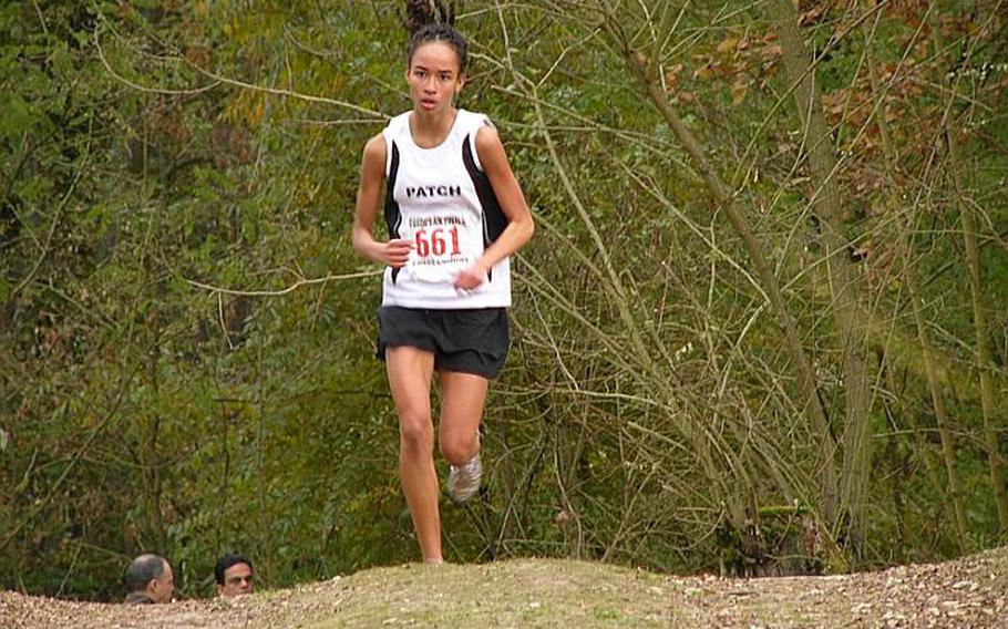 Patch sophomore Morgan Mahlock is all alone as she heads over a small rise in the course en route to her meet-winning time of 19 minutes, 44.03 seconds, 32 seconds ahead of Jessica Kafer of Ramstein.