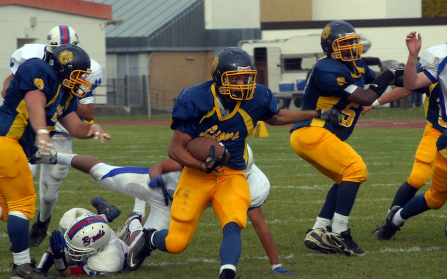 Heidelberg blockers clear the way for senior Sterling Jones during the Lions'  36-7  victory over Ramstein in a Division I playoff game. Jones rushed for two touchdowns and 174 yards on 19 carries for the Lions. He also began the game with an 87-yard TD run on the second play from scrimmage.