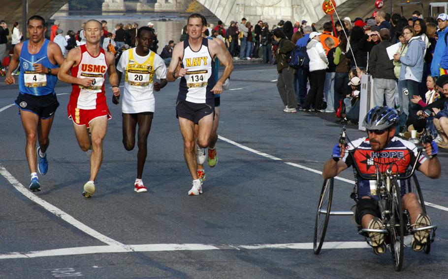 Running together near the 10-mile mark are four competitors who would finish in the top ten. They are, left to right, Jose Miranda-Diaz (10th), Sean Barrett (third), Ronald Kurui (second) and John Mentzer (fourth).