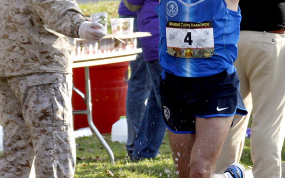 Jose Miranda-Diaz cools off at a water stop near the 16-mile mark, on his way to a 10th-place finish.