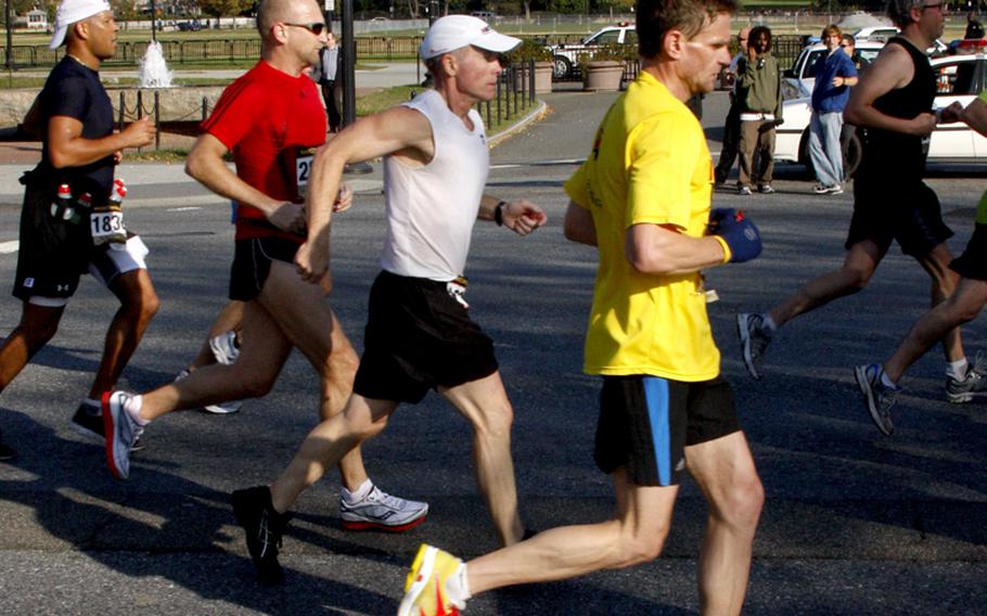 Runners on Constitution Ave. pass the White House, 17 miles into the race.
