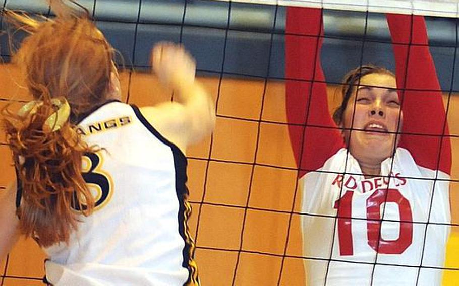 American School In Japan freshman Liz Thornton tries to spike past the block of Nile C. Kinnick junior Emily Stith during Thursday's Kanto Plain Association of Secondary Schools girls volleyball match at Mustang Valley, ASIJ's Chofu campus in western Tokyo. Kinnick won in four sets, 25-11, 25-21, 23-25, 25-16.