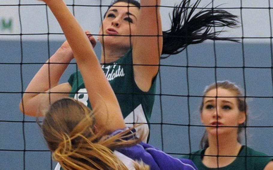 Bahrain's Bethany Krenek, foreground, and Jacqueline Lund of Naples battle at the net in a Division II match won by Naples 25-21, 25-19.