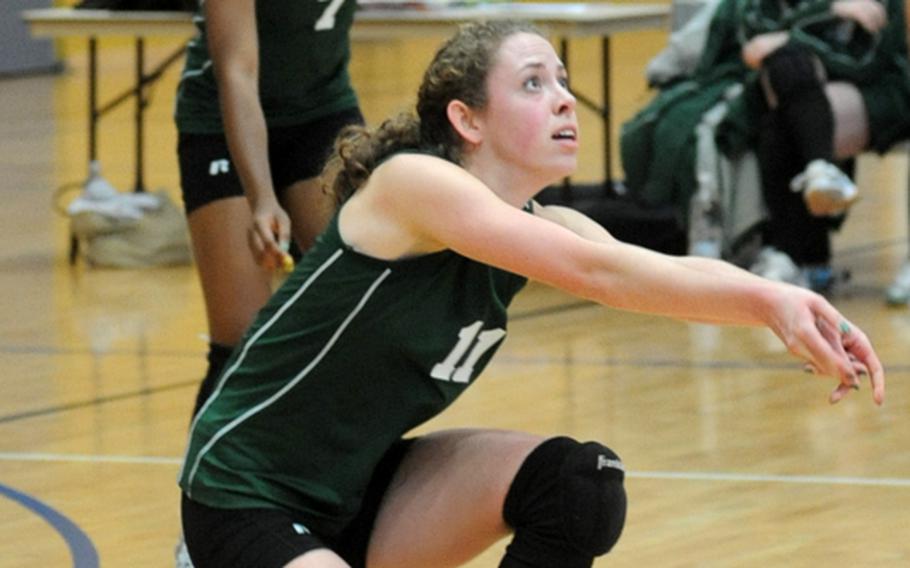 SHAPE's Elizabeth Cowther, watched by teammate Paris Johnson, gets under a Wiesbaden serve in their Division I match at the DODDS-Europe volleyball finals in Ramstein. SHAPE won 11-25, 25-14, 25-13.