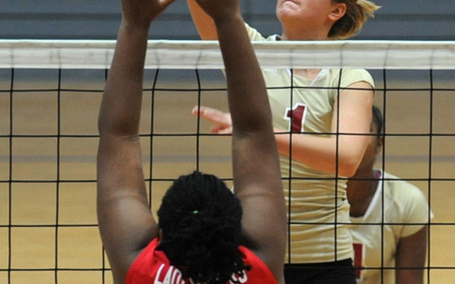 Vilseck's Anna Muzzy slams the ball over the net as Kaiserslautern's Courtney Woods defends in opening-day Division I action at the DODDS-Europe volleyball finals. Vilseck, the tourney's third seed, beat sixth-seeded Kaiserslautern 25-10, 25-20.