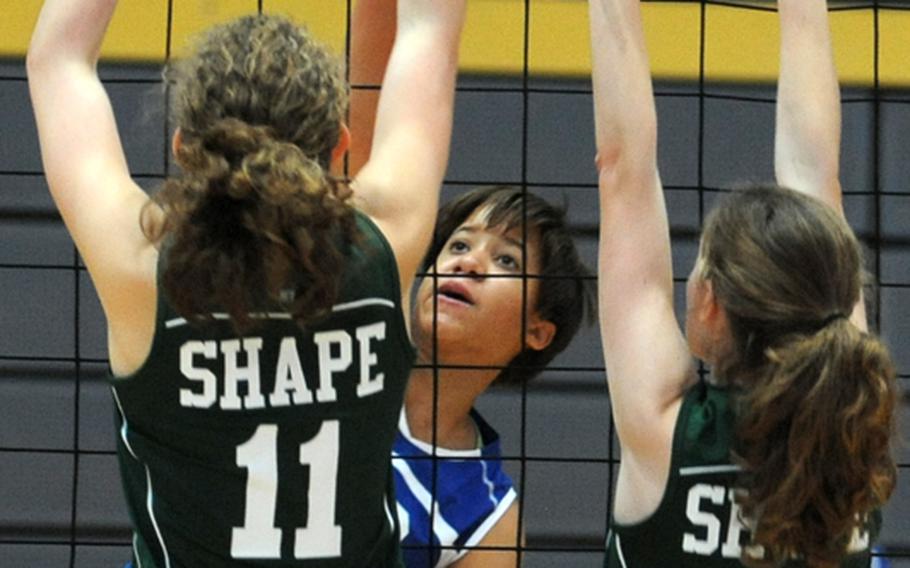 SHAPE&'s Elizabeth Cowther, left, and Allyson Kulmayer defend against Wiesbaden's LeAndra Thomas in their Division I match at the DODDS-Europe volleyball finals in Ramstein. SHAPE won 11-25, 25-14, 25-13.
