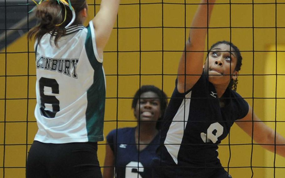 Alconbury's Savanna Fourham, left, defends against Sanasia Little of Menwith Hill in their Division III semifinal on Friday. Menwith Hill won 25-19, 25-21, 23-25, 30-28 and will face Rota in Saturday's final at the DODDS-Europe volleyball championships.