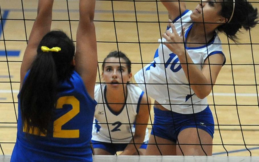 Rota's Natalia Rivera, right, slaps the ball back over the net against Sigonella's Erica Cartright in a Division III semifinal at the DODDS-Europe volleyball championships on Friday. Rota won the match 25-23, 25-21, 25-22, and will face Menwith Hill in the finals. Watching the action is Aspen Luna.