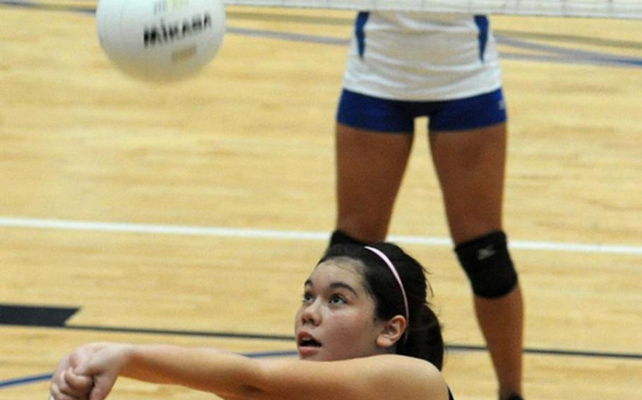 Sigonella's Mikaela Palmer bumps the ball as Rota's Gabriela Rivera watches in one of the Division III semifinals on Friday.  Rota won the match 25-23, 25-21, 25-22, and will face Menwith Hill in the finals.