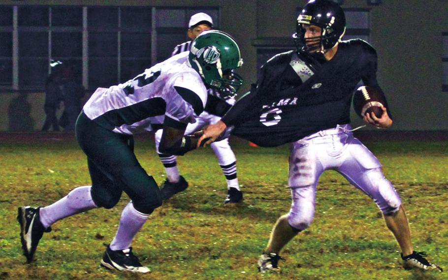 Daegu American Warriors defender Watson Wallace sacks Zama American Trojans quarterback Matt Cole during Saturday's 2010 Far East High School Division II football championship game at Trojans Field, Zama American High School, Camp Zama, Japan. Daegu won, 28-2.