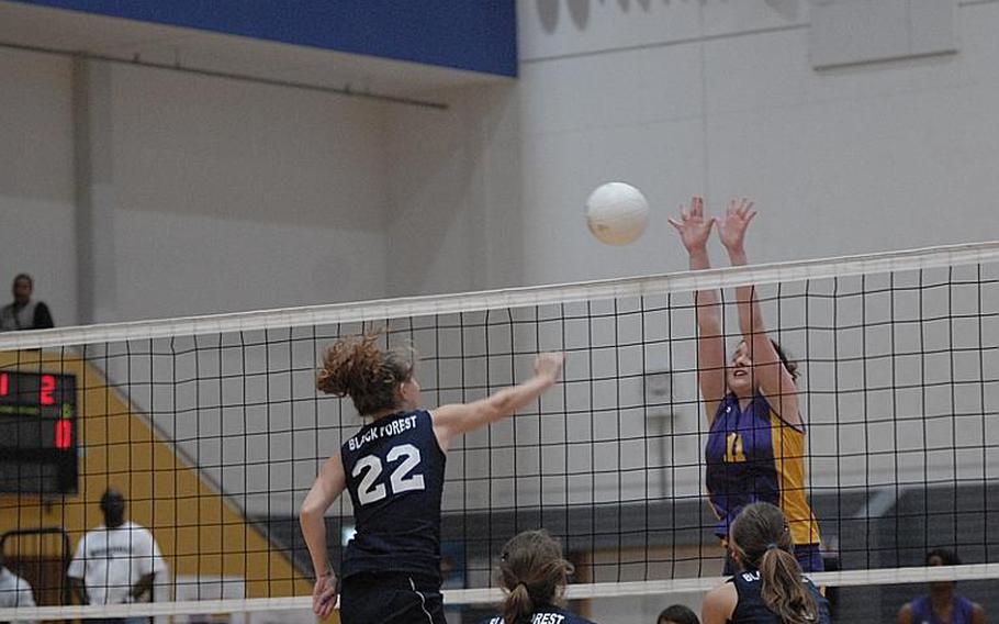 Black Forest Academy's Kate Woodward tries to knock the ball past Mannheim's Emma Roberts Saturday at the DODDS-Europe girls volleyball championships at Ramstein Air Base. BFA defeated Mannheim to defend its Division II championship.