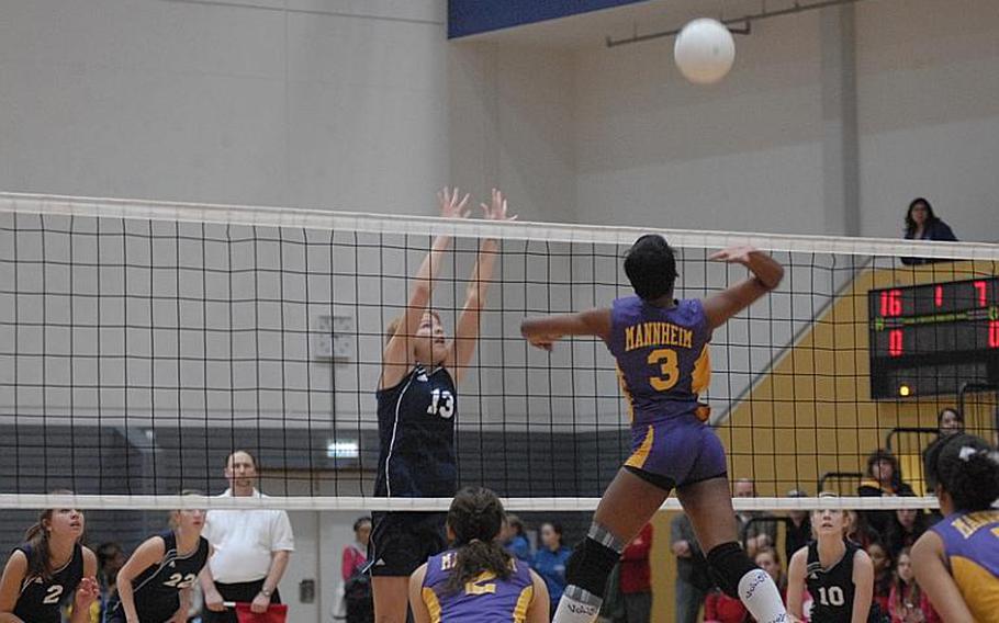Mannheim Senior Kierra Tucker goes up for the spike as senior Kara Brown from the Black Forest Academy tries to position herself for the block. BFA defeated Mannheim in straight sets Saturday to repeat as DODDS-Europe Divison II girls volleyball championship.