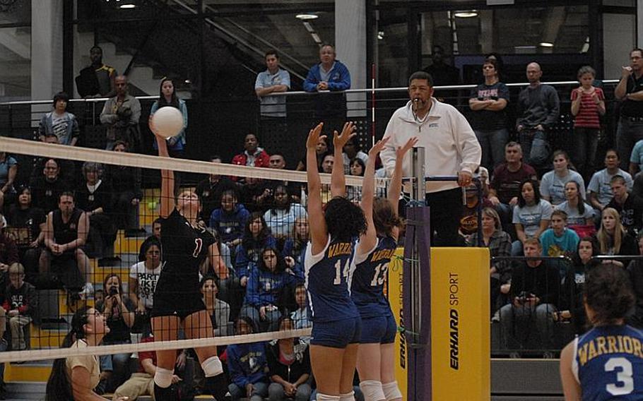 Vilseck senior Anna Muzzy goes for a kill as Wiesbaden senior LeAmber Thomas, left, and sophomore Kirsten Velsvaag try to keep the ball on the Vilseck side.  Vilseck defeated Wiesbaden at Ramstein Air Base to capture the Division I DODDS girls volleyball championship.