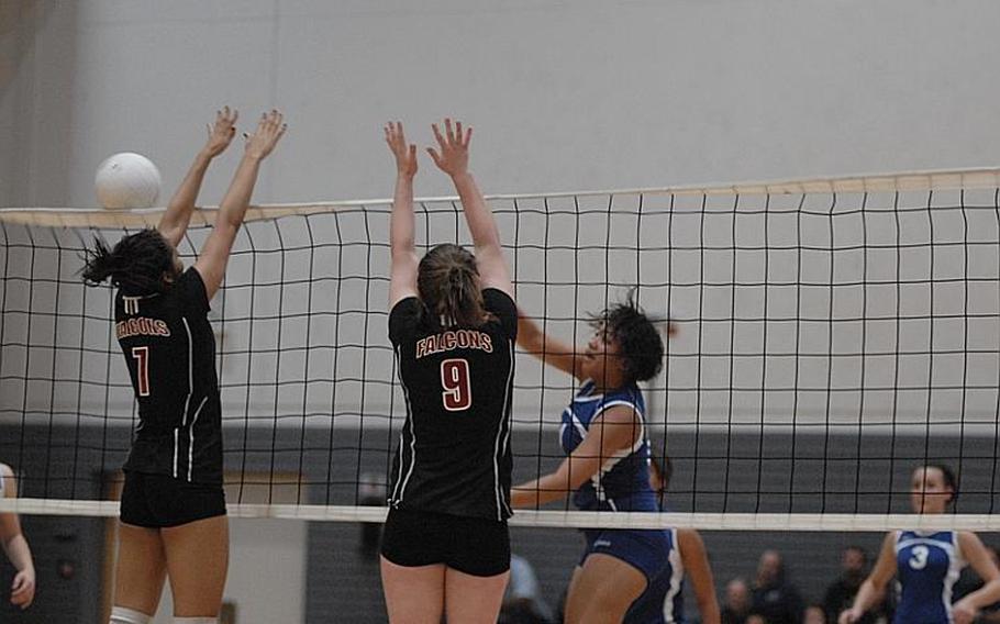 Vilseck junior Sidni Beaulieu, left, and junior Taylor Hall try to knock the shot back by Wiesbaden senior LeAmber Thomas during Saturday's DODDS-Europe girls volleyball championships.  Vilseck soared past the Warriors in straight sets to capture the Division I title.