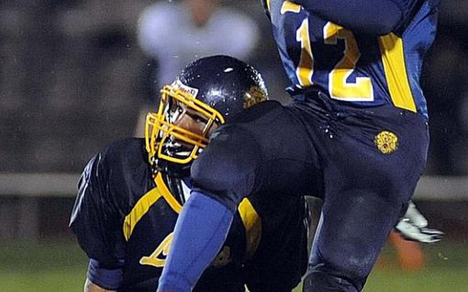 Heidelberg's Kevin Gray, left, and Rene Johnson watch as Johnson's field goal sails through the crossbars, giving the Lions a 23-20 overtime victory in the Division I championship game against Wiesbaden.