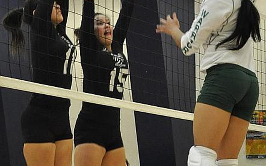 Daegu American outside hitter Leanne Quizon tries to move the ball past Osan American's Lydia Kim, left, and Alina Hauter during Monday's pool-play match in the Far East High School Division II Girls Volleyball Tournament at Potter FItness & Sports Center, Misawa Air Base, Japan. Defending champion Daegu beat Osan, the 2007 and 2008 champion, 25-23, 25-21.