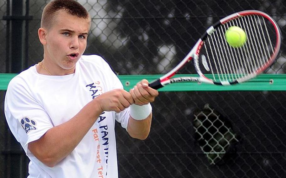 Kadena's Donovan Tracy whips a backhand return against Nate Rivera of Nile C. Kinnick during Monday's first-round boys singles match in the Far East High School Tennis Tournament at Risner Tennis Complex, Kadena Air Base, Okinawa. Tracy beat Rivera 8-6.